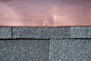 Asphalt shingles with copper flashing
