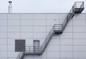A grey industrial building with stairwell