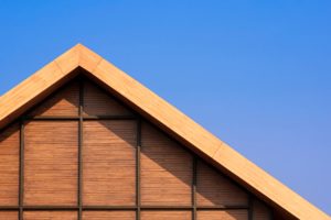 Wooden gable roof against blue sky